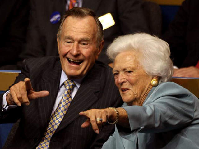 Former President George H.W. Bush and first lady Barbara Bush point from their seats on day two of the Republican National Convention on September 2, 2008 in St. Paul, Minnesota. (Photo by Justin Sullivan - Getty Images)