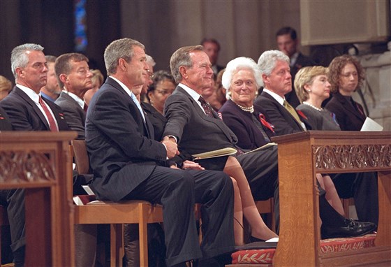 President George W. Bush grasps the hand of his father, former President George H.W. Bush, three days after the Sept. 11 terrorist attacks in 2001.The White House - Getty Images.