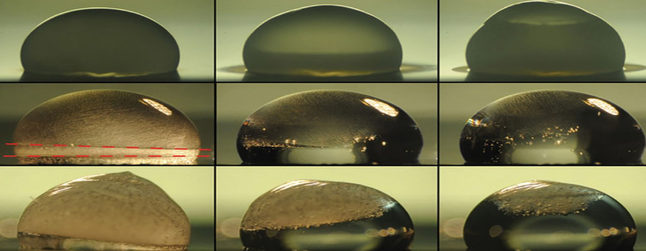 Images of a droplet on a surface show the process of freezing (top row), during which condensation temporarily forms on the outside of the droplet as it freezes. The next two rows show the droplet thawing out on a surface coated with the new layered material. In the middle row, the droplet is heated by the coating immediately upon freezing, and the dashed lines show where the freezing at top is just catching up with the thawing from below. The bottom row shows a slower thawing process. Under identical conditions, the droplet stays frozen without the new coating. (The Varanasi Research Group)