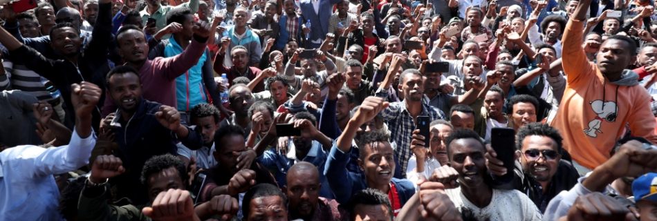 At least 400 young men joined the protest at Jawar's house in the capital Addis Ababa while some two dozen police officers stood nearby [Tiksa Negeri:Reuters]