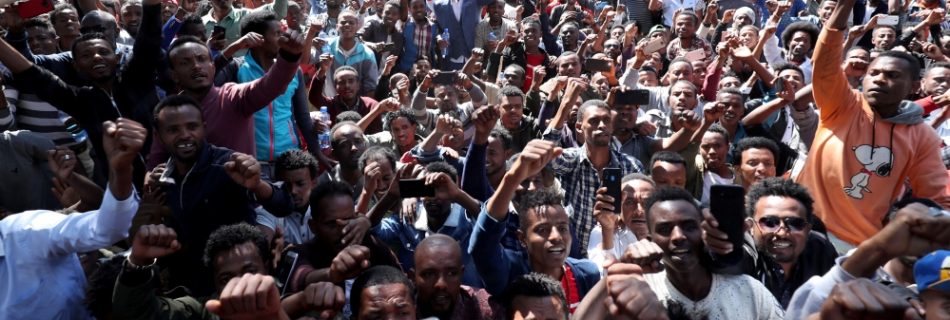 At least 400 young men joined the protest at Jawar's house in the capital Addis Ababa while some two dozen police officers stood nearby [Tiksa Negeri:Reuters]