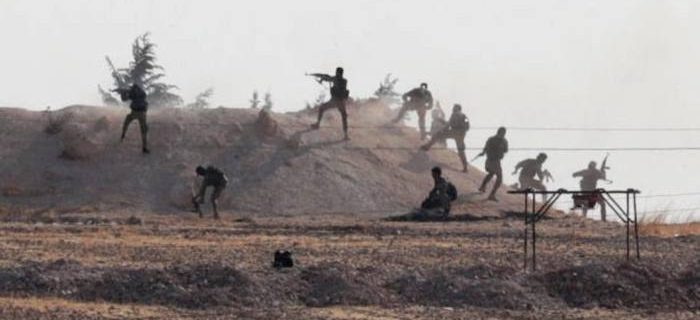 Turkey-backed Syrian rebel fighters in action in the village of Yabisa, near the Turkish-Syrian border, on Sunday © Reuters