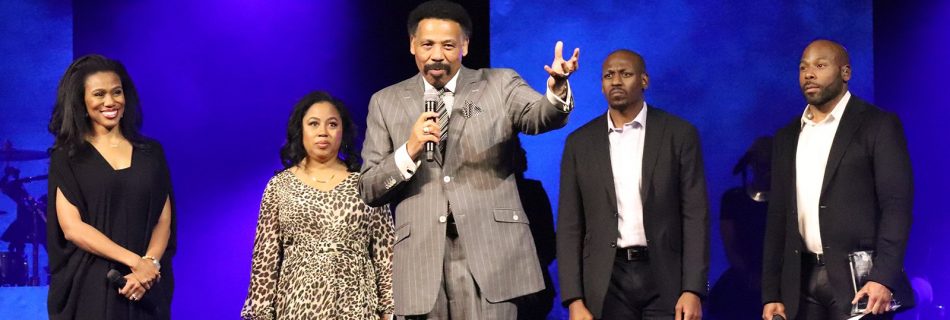 Pastor Tony Evans, center, speaks during the Kingdom Legacy Live event on Friday, Nov. 8, 2019, in Dallas. Evans’ children stand behind him. (Image RNS by Adelle M. Banks)