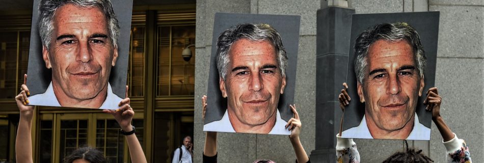 A protest group called "Hot Mess" hold up signs of Jeffrey Epstein in front of the Federal courthouse on July 8, 2019 in New York City. (Image by Stephanie Keith/Getty Images)