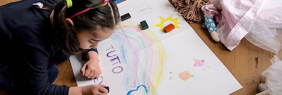 A girls makes a drawing reading "Everything is going to be alright", as part of school homework on the COVID-19 coronavirus on March 12, 2020 in Manta, near Cuneo, Northwestern Italy. (Images Marco Bertorello/AFP/GETTY Images)