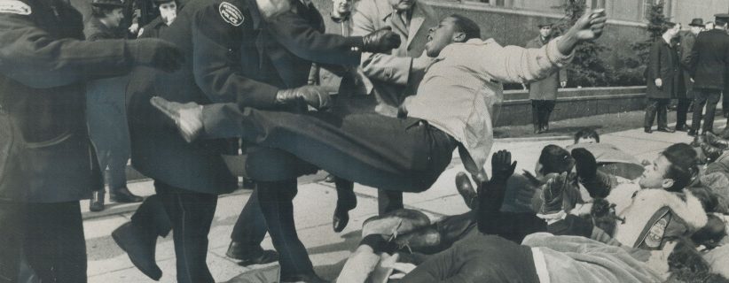 Police Heaveto is given a black youth who was among about 80 student demonstrators who marched on the U.S. consulate on University Ave. to back civil rights workers in Alabama on March 16, 1966. (Gerry Barker/Toronto Star/Getty Images)