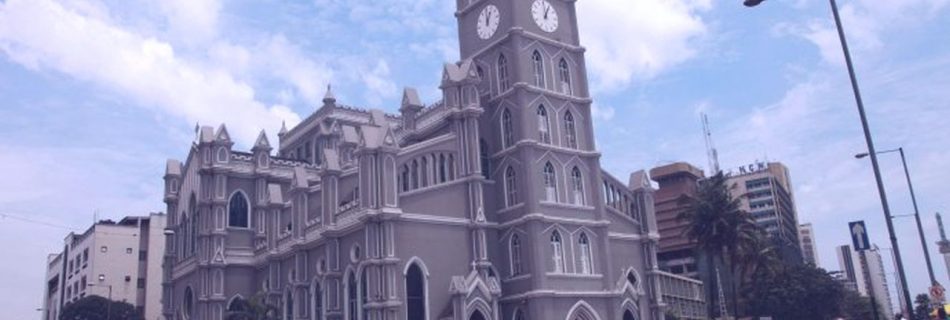 People are pictured in a file photo walking past the cathedral in Lagos, Nigeria. Nigerian bishops want an end to violence in southern Kaduna state, where more than 170 people have been killed this year. (Credit: Akintunde Akinleye/Reuters via CNS.)