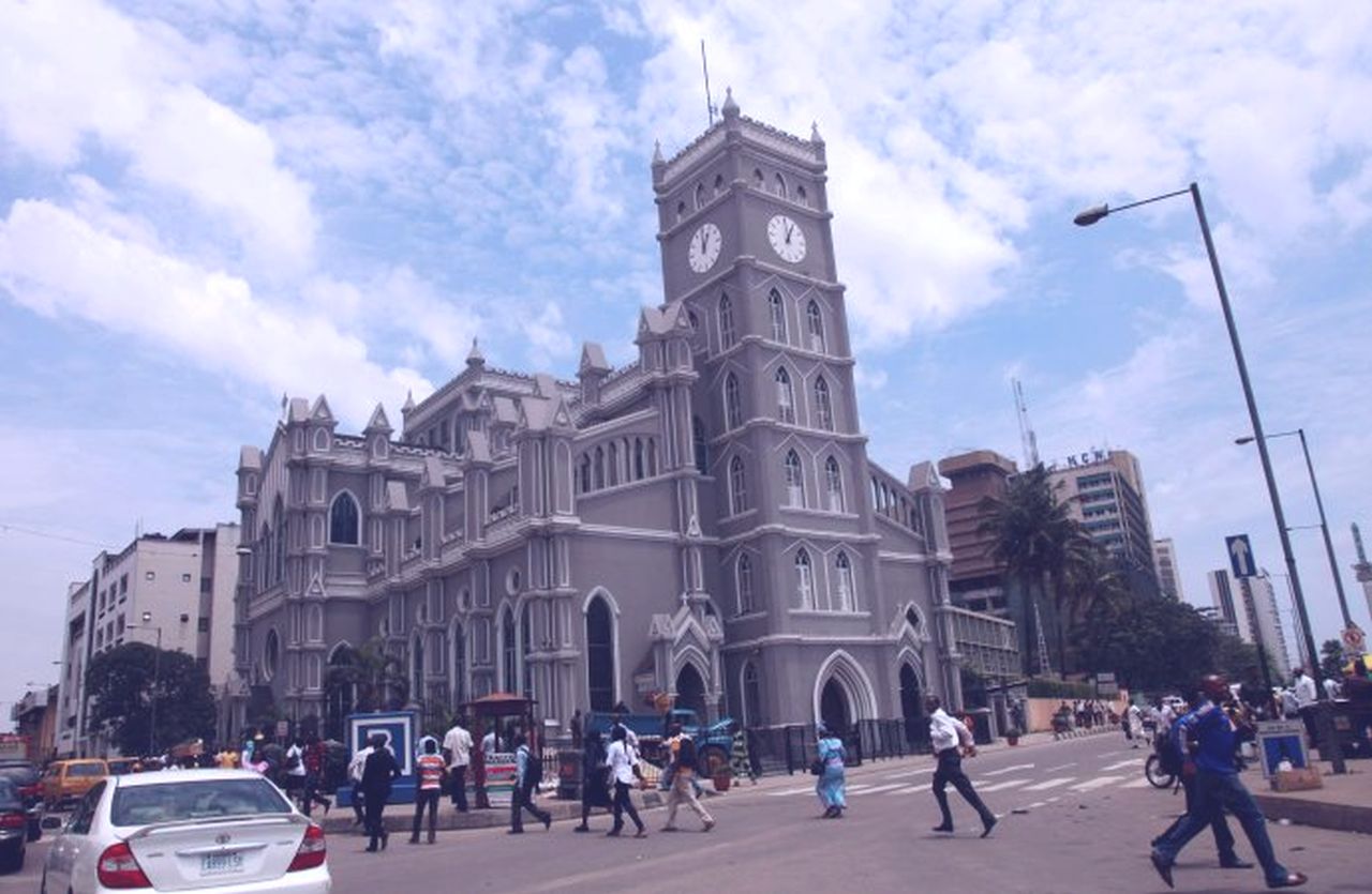 People are pictured in a file photo walking past the cathedral in Lagos, Nigeria. Nigerian bishops want an end to violence in southern Kaduna state, where more than 170 people have been killed this year. (Credit: Akintunde Akinleye/Reuters via CNS.)