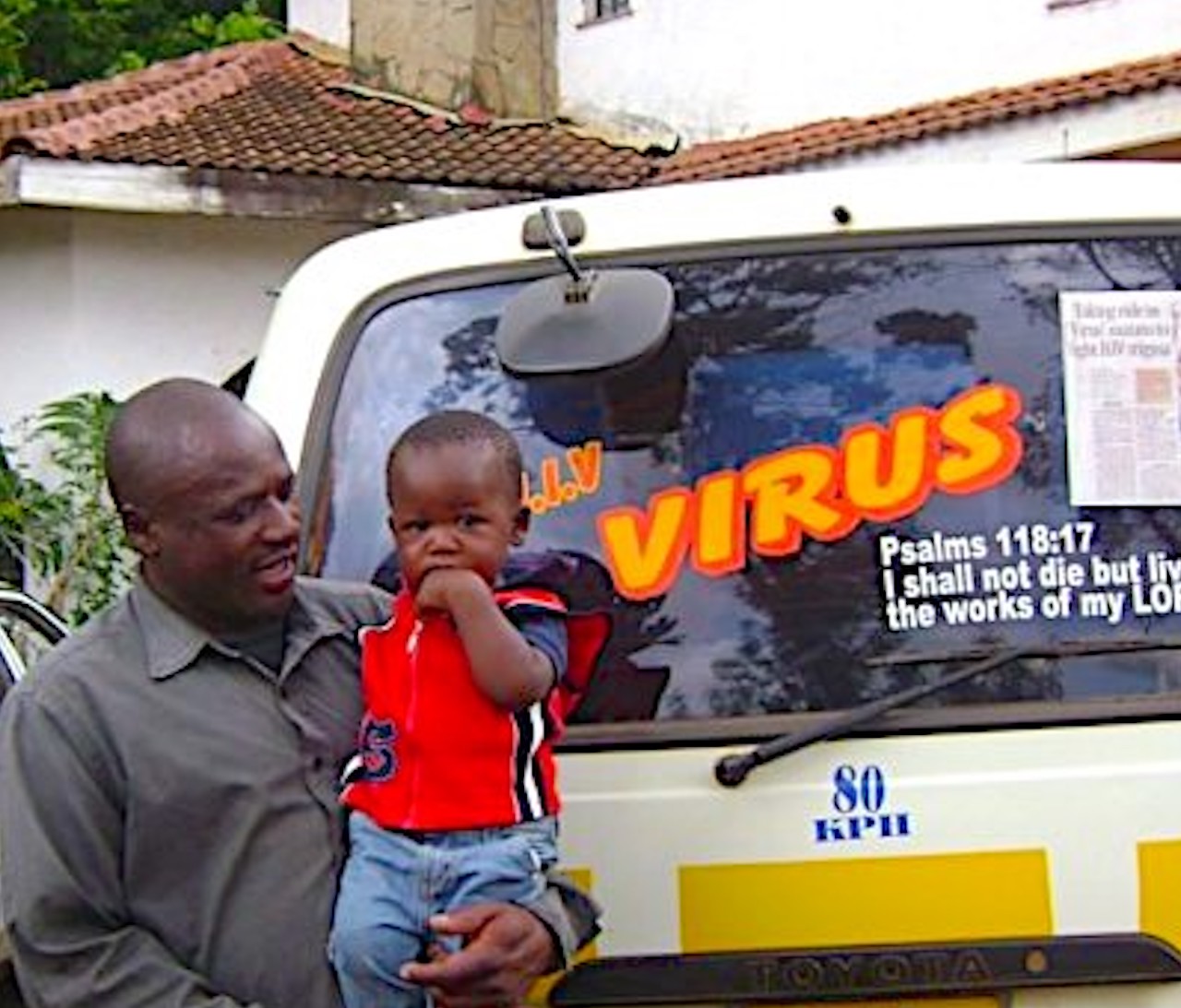 A FORUM member “living positively with AIDS,” pictured with his son. He uses his matatu (taxi) to send messages to the community about positive living and preventing HIV/AIDS