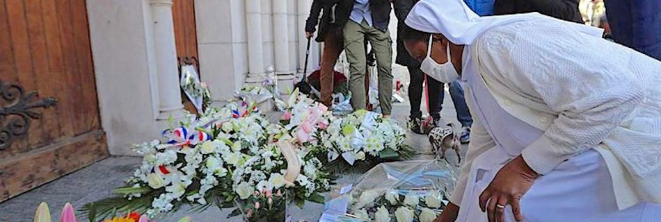 Two nuns lay flowers in front of the Notre-Dame de l'Assomption Basilica in Nice on October 30, 2020 during a tribute to the victims killed by a knife attacker the day before (Image by AFP)